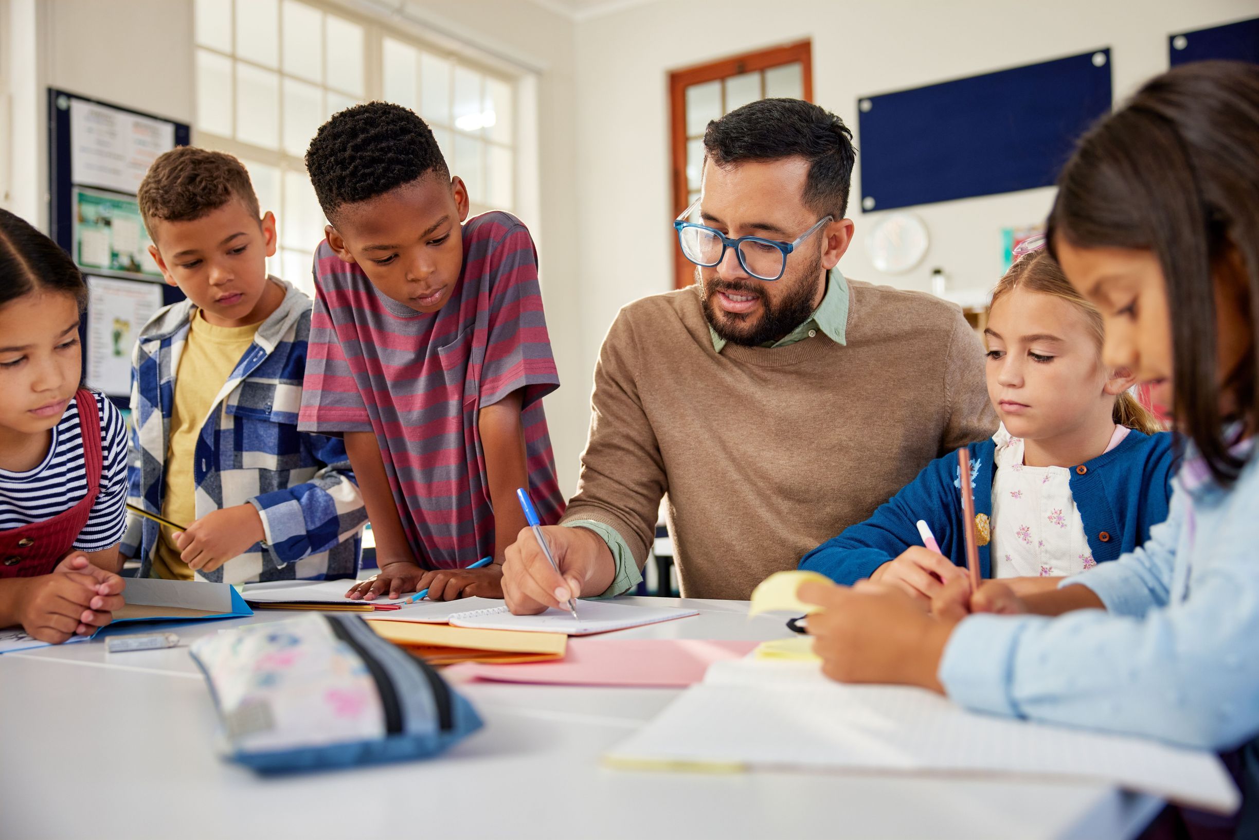 Teacher helping elementary school students